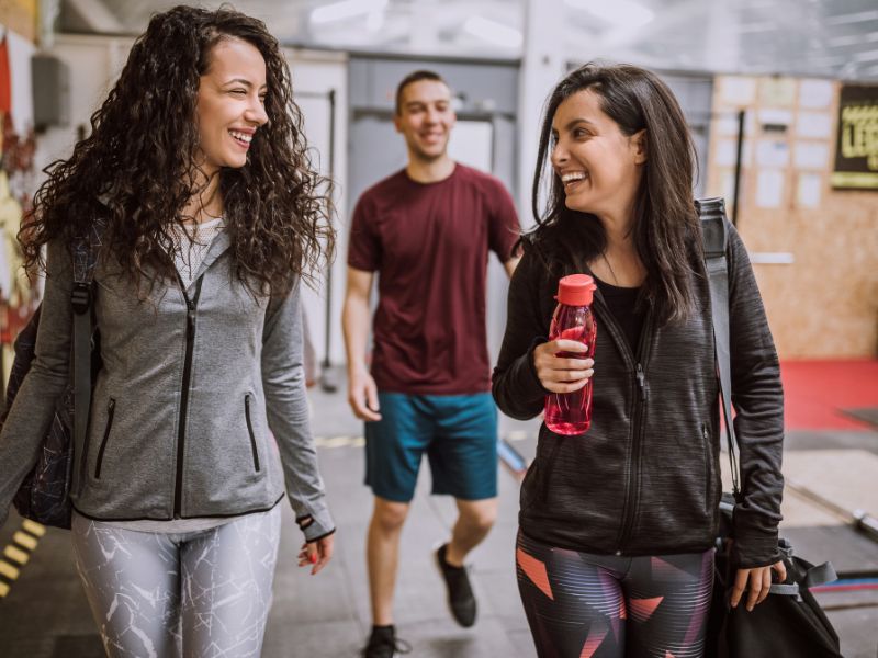 A group of people walking and laughing in workout clothes after joining Dr. Selim's medical weight loss program.